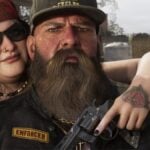 An unknown couple holds a Colt Python-inspired revolver.